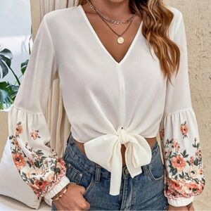Cropped shirt- long sleeved with ties in the front. Floral decorative sleeves